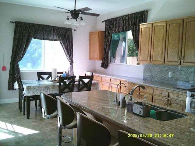 3030 Golf Dr W, Chowchilla, CA 93610 - kitchen featuring plenty of natural light, a ceiling fan, a sink, and light tile patterned floors