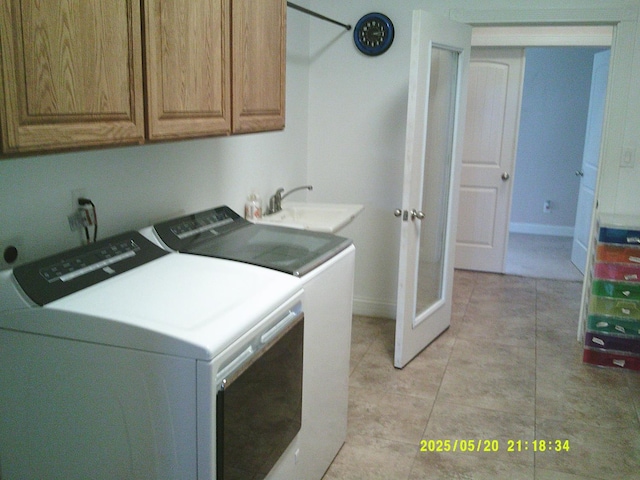 3030 Golf Dr W, Chowchilla, CA 93610 - laundry room featuring independent washer and dryer, cabinet space, baseboards, and light tile patterned floors