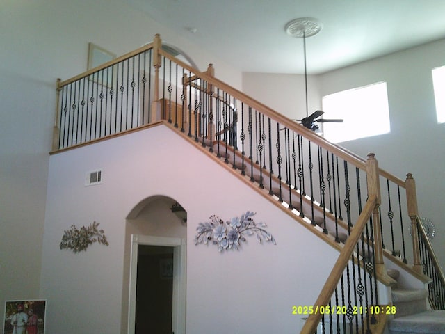 3030 Golf Dr W, Chowchilla, CA 93610 - staircase featuring arched walkways, ceiling fan, and a towering ceiling