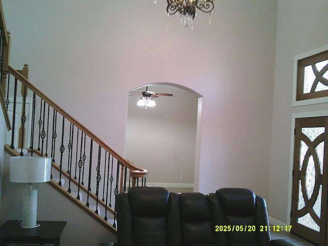 3030 Golf Dr W, Chowchilla, CA 93610 - entrance foyer with a high ceiling, arched walkways, stairs, a ceiling fan, and baseboards