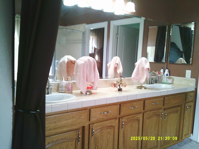 3030 Golf Dr W, Chowchilla, CA 93610 - full bathroom featuring double vanity and a shower with door