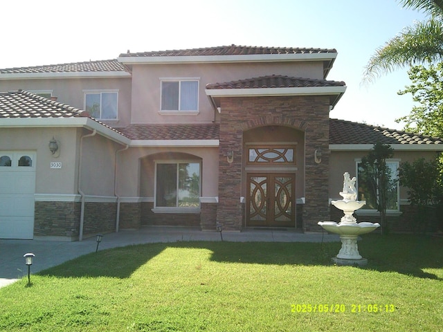 3030 Golf Dr W, Chowchilla, CA 93610 - doorway to property featuring stone siding, stucco siding, a yard, a tiled roof, and an attached garage