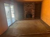 1212 Phillip St, Madera, CA 93638 - unfurnished living room with a fireplace