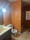 1212 Phillip St, Madera, CA 93638 - bathroom with toilet, vanity, and baseboards