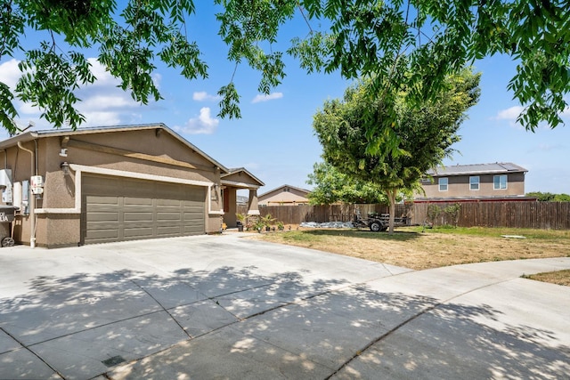 2326 W Flagstaff, Visalia, CA 93291 - view of front facade featuring concrete driveway, an attached garage, and stucco siding