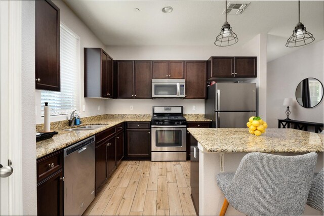 2326 W Flagstaff, Visalia, CA 93291 - kitchen with appliances with stainless steel finishes, a sink, light wood-style flooring, and healthy amount of natural light