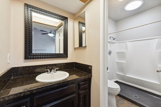 3591 W Harvard Ave, Fresno, CA 93722 - full bathroom featuring a stall shower, toilet, vanity, and ceiling fan