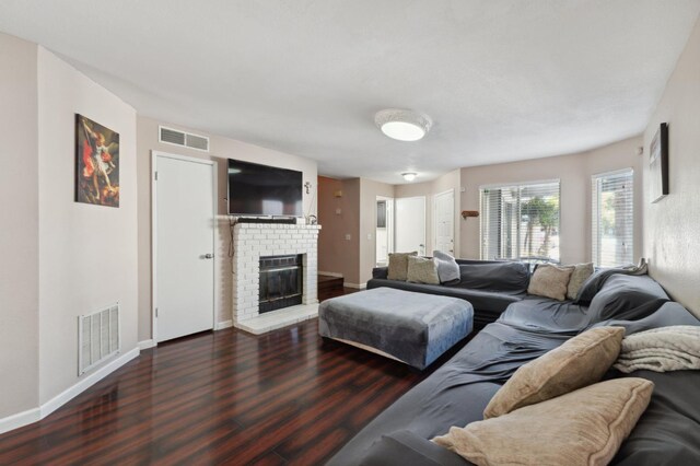 3591 W Harvard Ave, Fresno, CA 93722 - living area featuring wood finished floors, a brick fireplace, and baseboards