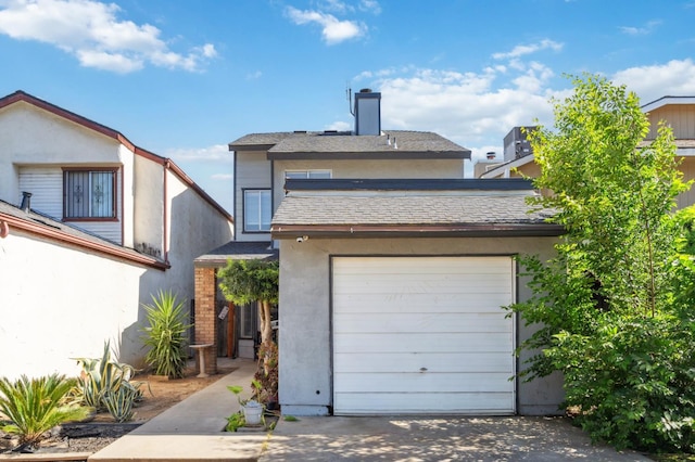 3591 W Harvard Ave, Fresno, CA 93722 - view of front of property featuring stucco siding, a chimney, and driveway