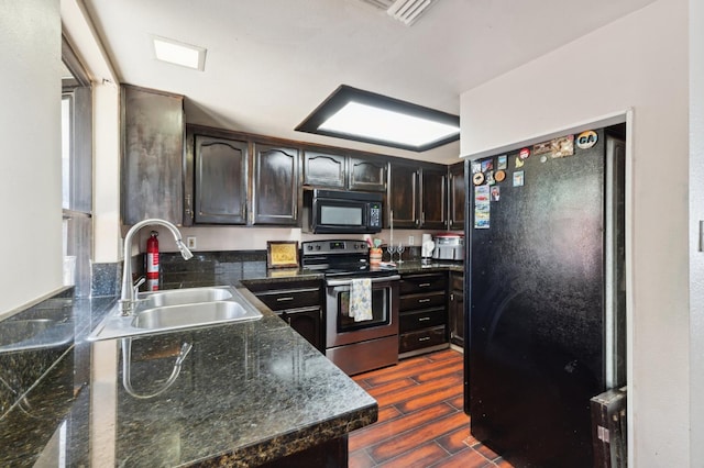 3591 W Harvard Ave, Fresno, CA 93722 - kitchen with black appliances, a sink, dark brown cabinets, and dark wood-type flooring