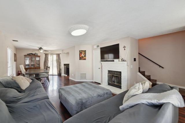 3591 W Harvard Ave, Fresno, CA 93722 - living room with a fireplace, baseboards, wood finished floors, and a ceiling fan