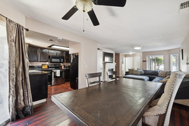 3591 W Harvard Ave, Fresno, CA 93722 - dining area with a fireplace, dark wood-type flooring, and ceiling fan
