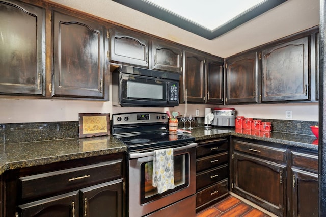3591 W Harvard Ave, Fresno, CA 93722 - kitchen with black microwave, stainless steel electric range, dark brown cabinets, and dark stone counters
