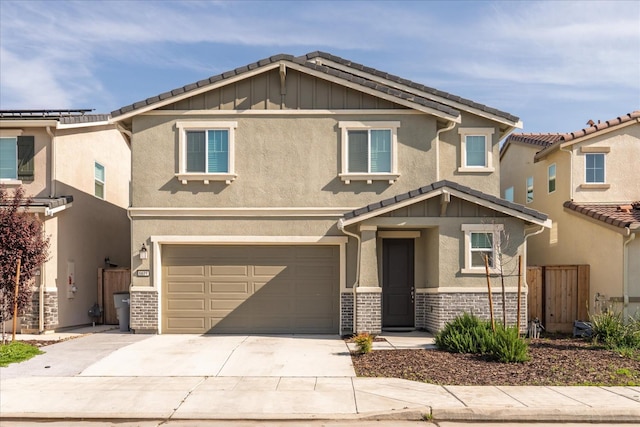 6618 E Grant Ave, Fresno, CA 93727 - view of front of house with a garage, concrete driveway, stucco siding, and a tiled roof