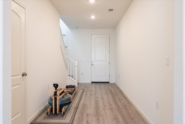 6618 E Grant Ave, Fresno, CA 93727 - hallway with light wood finished floors, stairway, baseboards, and recessed lighting