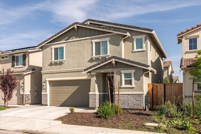 6618 E Grant Ave, Fresno, CA 93727 - view of front of property featuring an attached garage, driveway, stone siding, and stucco siding