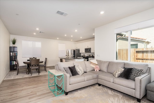 6618 E Grant Ave, Fresno, CA 93727 - living room featuring recessed lighting, light wood-type flooring, and baseboards