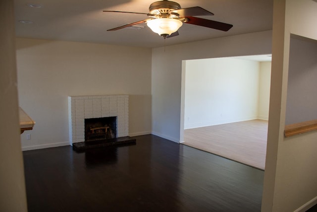 1913 N Waukena Way, Hanford, CA 93230 - unfurnished living room with dark wood-style floors, ceiling fan, baseboards, and a brick fireplace