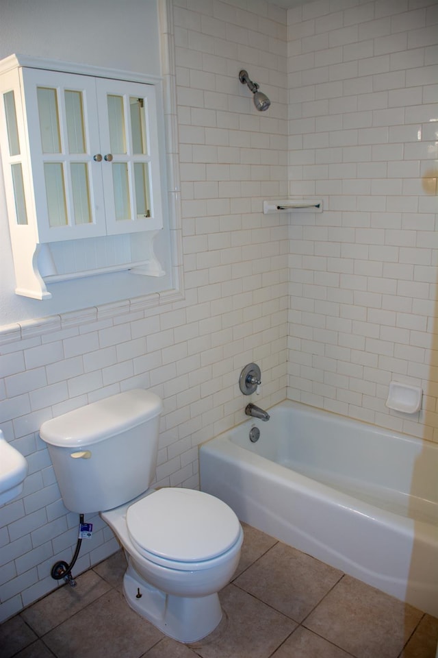 1913 N Waukena Way, Hanford, CA 93230 - full bathroom with tile patterned floors, toilet, tile walls, and shower / washtub combination