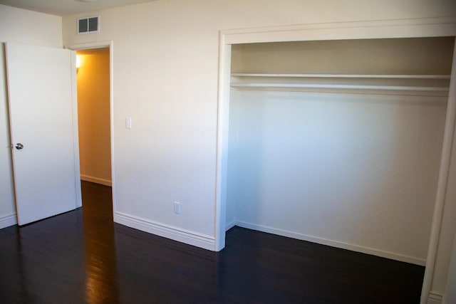 1913 N Waukena Way, Hanford, CA 93230 - unfurnished bedroom featuring dark wood-type flooring, a closet, and baseboards