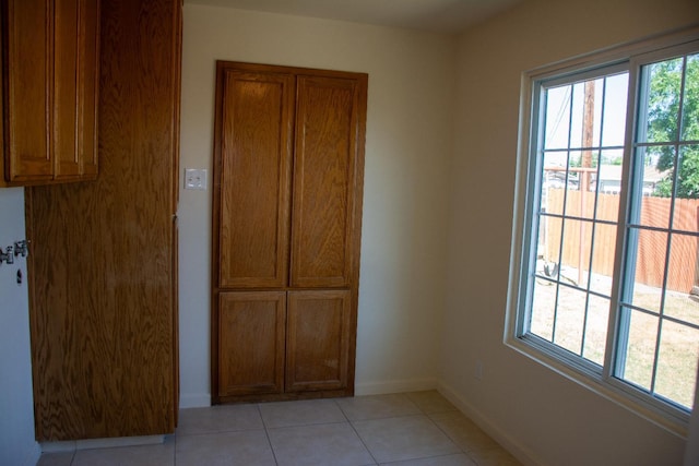 1913 N Waukena Way, Hanford, CA 93230 - unfurnished dining area with light tile patterned floors and baseboards