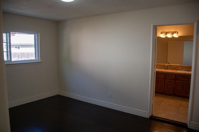 1913 N Waukena Way, Hanford, CA 93230 - spare room featuring dark wood finished floors, baseboards, and a sink