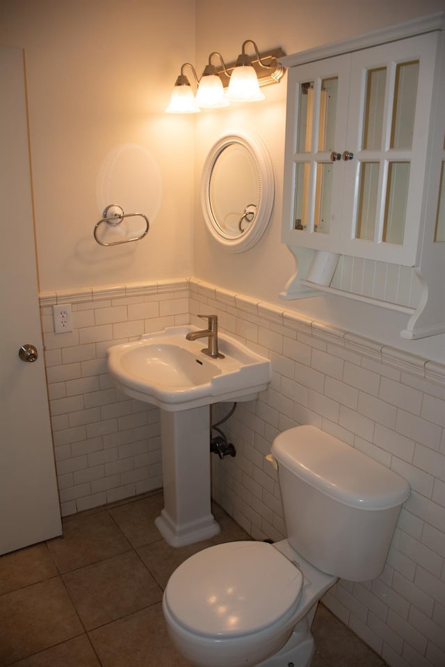 1913 N Waukena Way, Hanford, CA 93230 - bathroom with a wainscoted wall, tile walls, tile patterned flooring, and toilet