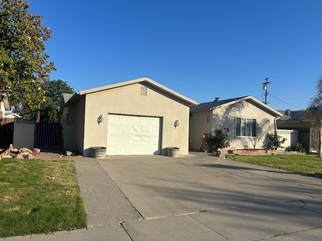 1913 N Waukena Way, Hanford, CA 93230 - single story home featuring a garage, stucco siding, concrete driveway, and a gate