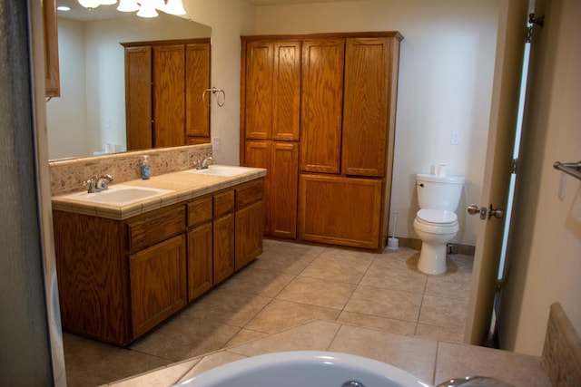 1913 N Waukena Way, Hanford, CA 93230 - bathroom featuring tile patterned flooring, toilet, and double vanity