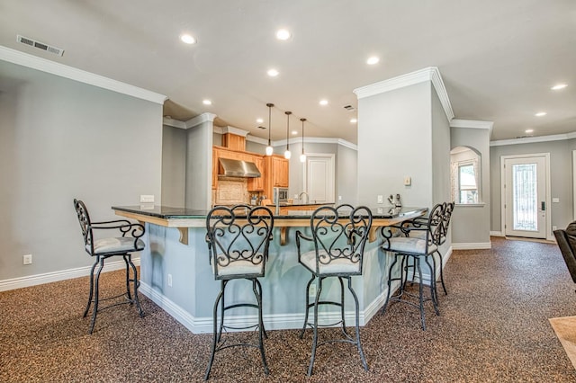 47307 Sunshine Terrace Dr, Coarsegold, CA 93614 - kitchen with baseboards, wall chimney range hood, ornamental molding, recessed lighting, and a kitchen bar