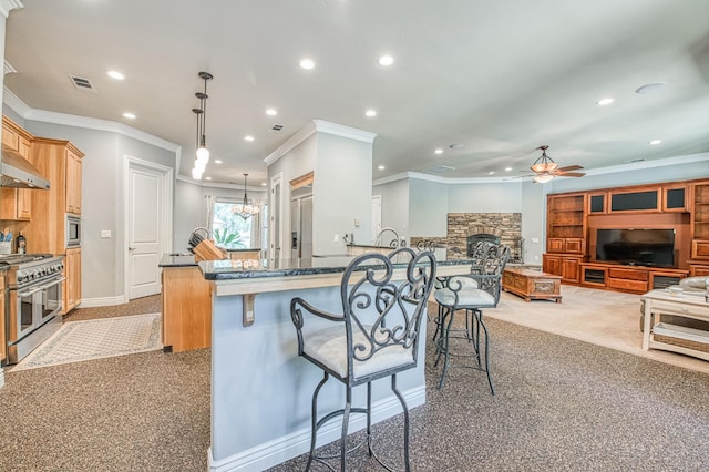 47307 Sunshine Terrace Dr, Coarsegold, CA 93614 - kitchen with stainless steel appliances, ceiling fan, a breakfast bar, recessed lighting, and a fireplace