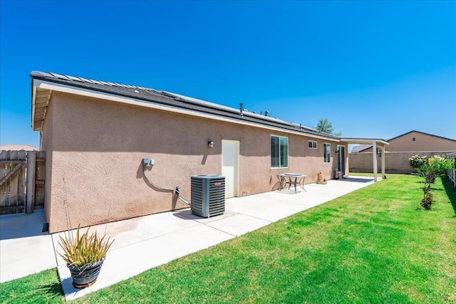 1799 Bolton Ave, Tulare, CA 93274 - back of property featuring central air condition unit, a patio, stucco siding, and a gate