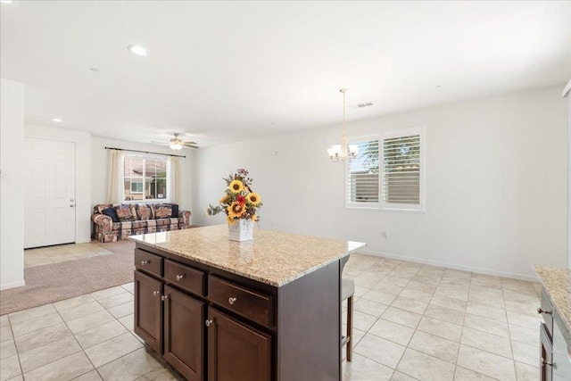 1799 Bolton Ave, Tulare, CA 93274 - kitchen featuring healthy amount of natural light, a kitchen breakfast bar, light tile patterned floors, a chandelier, and recessed lighting