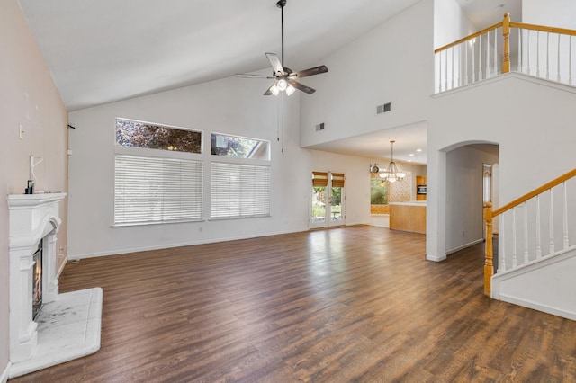 5422 W Calimyrna Ave, Fresno, CA 93722 - unfurnished living room featuring a ceiling fan, stairway, high vaulted ceiling, a chandelier, and wood finished floors