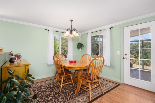 34133 Keller Rd, North Fork, CA 93643 - dining space featuring a chandelier, light wood-style flooring, crown molding, and plenty of natural light