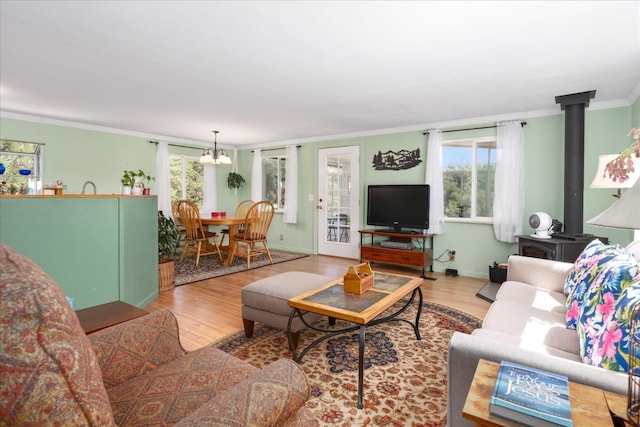 34133 Keller Rd, North Fork, CA 93643 - living area with ornamental molding, wood finished floors, a chandelier, and a wood stove
