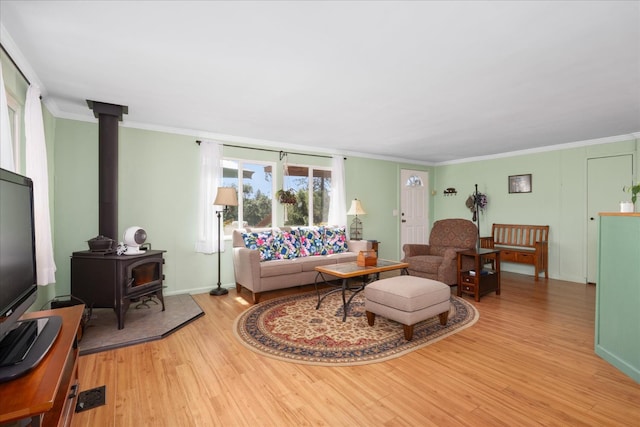 34133 Keller Rd, North Fork, CA 93643 - living room with light wood-type flooring, a wood stove, and crown molding