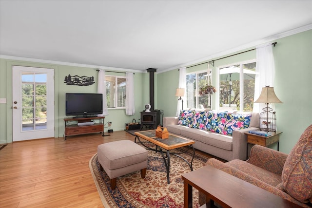 34133 Keller Rd, North Fork, CA 93643 - living area featuring a wood stove, crown molding, and light wood finished floors