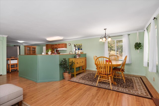 34133 Keller Rd, North Fork, CA 93643 - dining room with light wood-type flooring, a chandelier, and crown molding