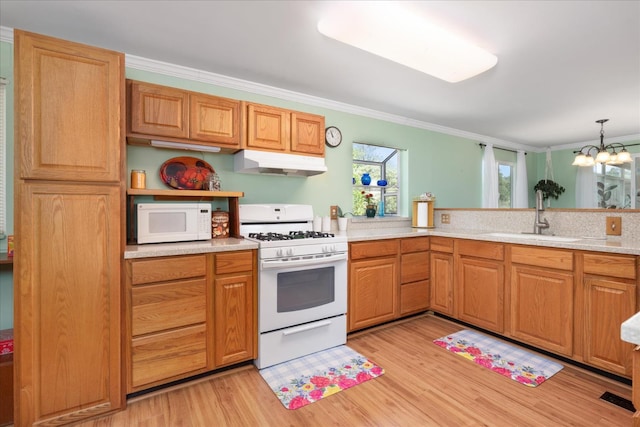 34133 Keller Rd, North Fork, CA 93643 - kitchen featuring white appliances, under cabinet range hood, ornamental molding, light wood finished floors, and light countertops