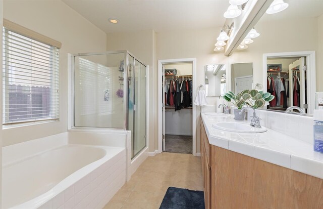 7026 E Dayton Ave, Fresno, CA 93737 - full bath with a spacious closet, double vanity, a stall shower, and a bath