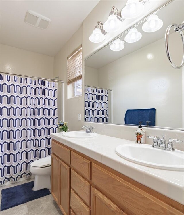 7026 E Dayton Ave, Fresno, CA 93737 - full bathroom with double vanity, toilet, and a shower with curtain