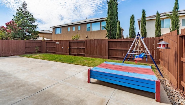 7026 E Dayton Ave, Fresno, CA 93737 - fenced backyard featuring a playground and a patio area