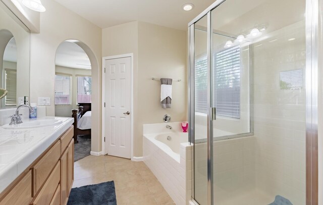 7026 E Dayton Ave, Fresno, CA 93737 - full bathroom with vanity, a bath, connected bathroom, a stall shower, and tile patterned flooring