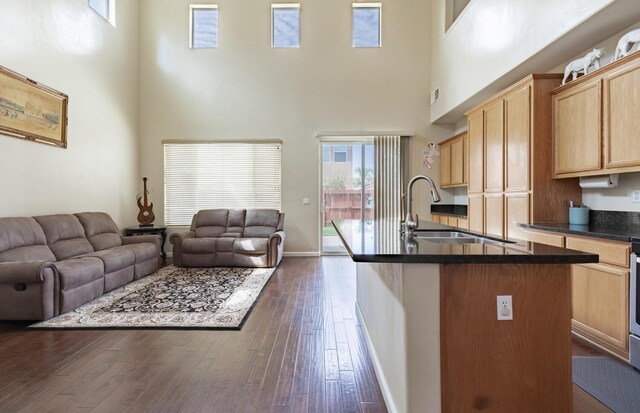 7026 E Dayton Ave, Fresno, CA 93737 - kitchen featuring a sink, a towering ceiling, open floor plan, dark countertops, and light brown cabinets