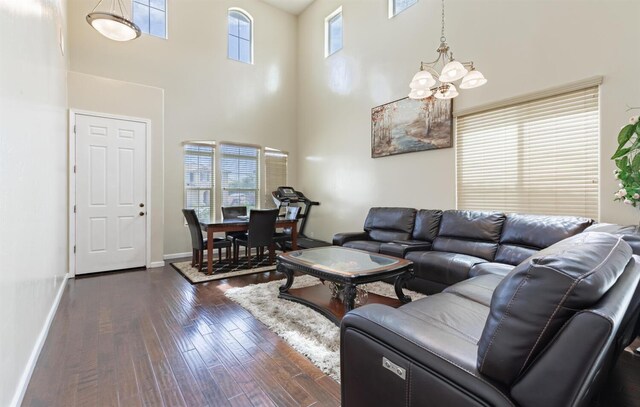 7026 E Dayton Ave, Fresno, CA 93737 - living area with a high ceiling, dark wood finished floors, a chandelier, and baseboards