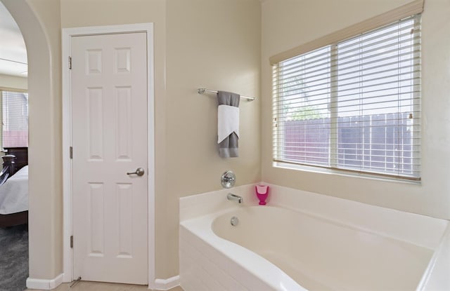 7026 E Dayton Ave, Fresno, CA 93737 - bathroom featuring connected bathroom, a garden tub, and plenty of natural light