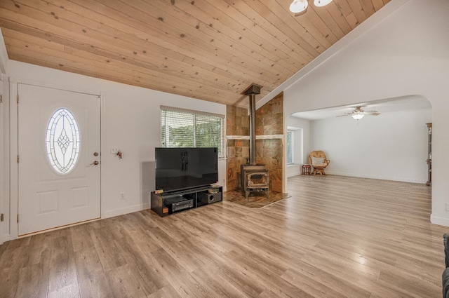 44719 Savage Rd, Coarsegold, CA 93614 - foyer entrance with a wood stove, wood finished floors, arched walkways, baseboards, and a ceiling fan