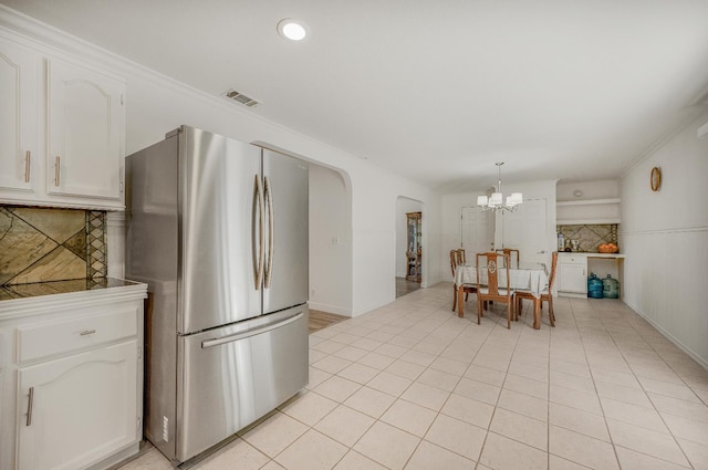 44719 Savage Rd, Coarsegold, CA 93614 - kitchen with freestanding refrigerator, a chandelier, white cabinets, tasteful backsplash, and light tile patterned floors