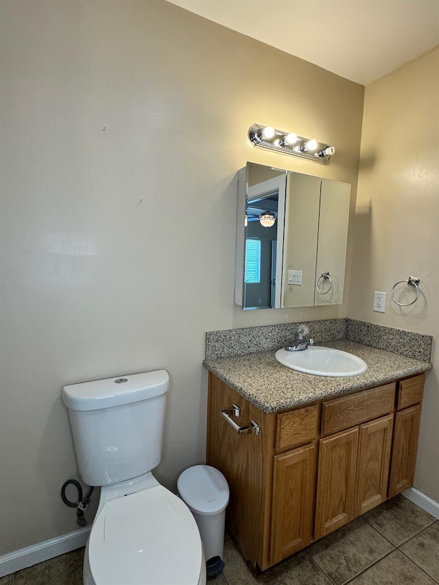 1382 N Thorne Ave, Fresno, CA 93728 - half bathroom featuring vanity, toilet, tile patterned floors, and baseboards